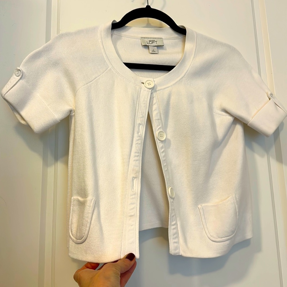 White short sleeve 3-button cardigan sweater.